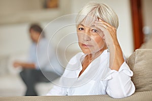 Aging is not for sissies. a senior woman looking sad while sitting on the sofa at home.