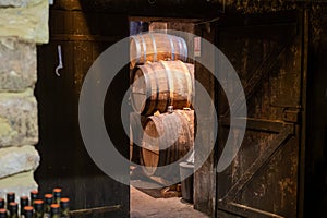 Aging process of cognac spirit in old French oak barrels in cellar in distillery in Cognac white wine region, Charente, Segonzac,