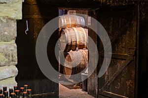 Aging process of cognac spirit in old French oak barrels in cellar in distillery in Cognac white wine region, Charente, Segonzac,