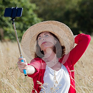 aging woman posing for outdoors selfy and vacation memories