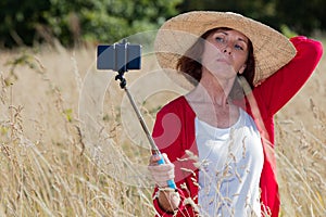 Aging woman posing for outdoors selfy and vacation memories