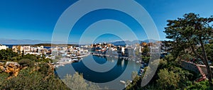 Agios Nikolaos City and Voulismeni Lake. Panorama of the beautiful of Agios Nikolaos. Panoramic view sea, lake with trees, sky and