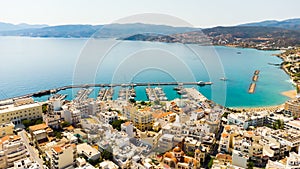 Agios Nikolaos. Crete. Greece. Buildings on the shore of Voulismeni Lake and boats at the pier