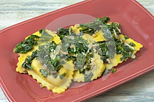 Agnolotti pasta with kale on plate