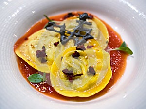 Agnolotti or ravioli stuffed pasta dish closeup