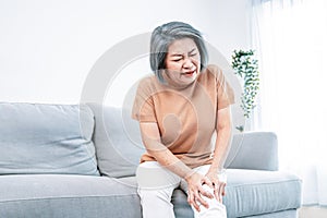 An agonizing elderly woman is experiencing chest pain.