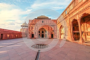 Agra Fort medieval palace architecture made of red sandstone with intricate wall art at Agra India