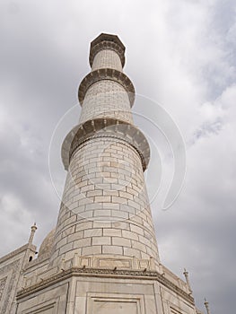 AGRA, INDIA - MARCH, 26, 2019: close up low angle shot of a marble minaret of the taj mahal