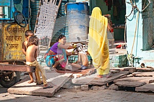 Agra/india-15.04.2019:Mother washing her kids on the indian street