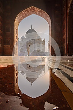 tourist standing in front entrance gate of Taj Mahal indian palace. Islam architecture. Door to the mosque