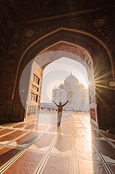 tourist standing in front entrance gate of Taj Mahal indian palace. Islam architecture. Door to the mosque
