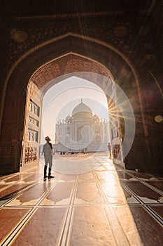 tourist standing in front entrance gate of Taj Mahal indian palace. Islam architecture. Door to the mosque