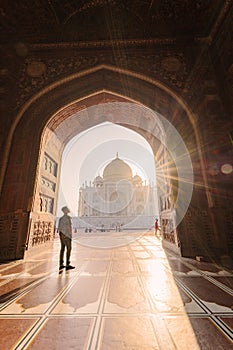 tourist standing in front entrance gate of Taj Mahal indian palace. Islam architecture. Door to the mosque