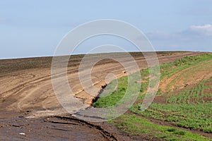 Agrarian fields after heavy rain, deposits of chernozem and various debris on the field