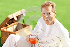 Agreeable man lying on the grass