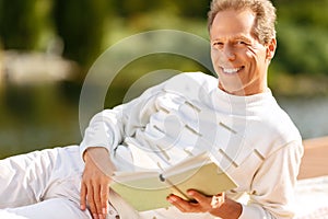 Agreeable man reading a book