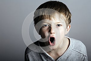 An agressive little boy shouts