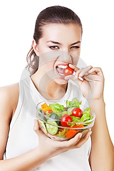 Agressive woman biting tomato