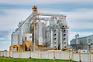 Agribusiness concept. Agro-processing and manufacturing plant with metal silos for grain storage, drying, cleaning agricultural