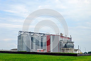 Agribusiness concept. Agro-processing and manufacturing plant with metal silos for grain storage, drying, cleaning agricultural