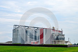 Agribusiness concept. Agro-processing and manufacturing plant with metal silos for grain storage, drying, cleaning agricultural