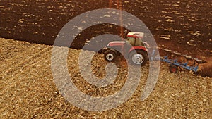 Agricultural background with tractor working on field.