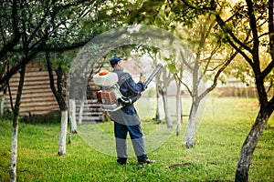 Agricultural details - farmer spraying pesticides and substances for local plant treatments