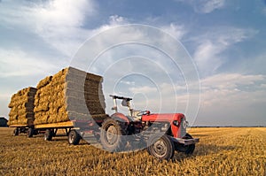 Agricultural Equipment red tractor with straw on t