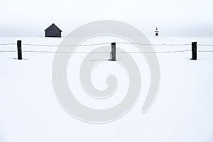 Agricultural fencing in snowy landscape