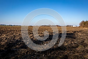 Agricultural field with bare soil in wintertime in Poland.