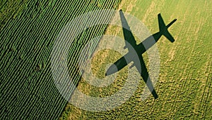 Agricultural Field With Plane Shadow: Concept Of Decarbonization And Biofuel. The Shadow Of The Aircraft Falls On The photo