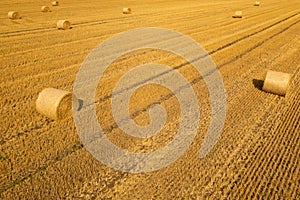 Agricultural field with straw bales. Top view of a landscape with hay rolls after autumn harvest.