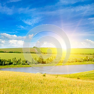 Agricultural fields, meadows, lake and bright sun