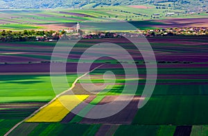 Agricultural fields on a summer day with Transylvania village