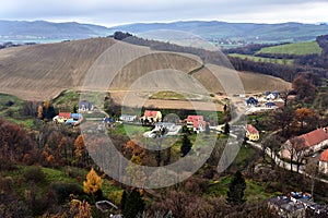 Agricultural landscape with houses, hill and forest