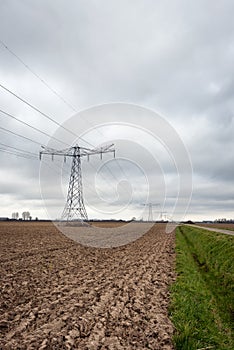 Agricultural landscape with a row of electricity pylons