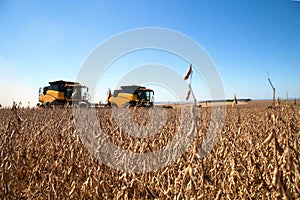 Agricultural machine harvesting soybean field.