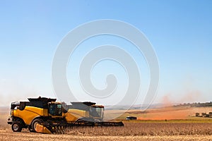 Agricultural machine harvesting soybean field.