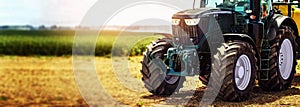 agricultural machinery farm equipment - tractor standing on the field. banner photo