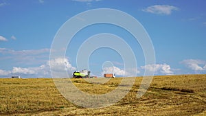 Agricultural machinery is harvesting. Combine harvester work in the field.