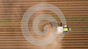 Agricultural machinery in the potato field cultivates the land