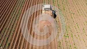 Agricultural machinery in the potato field cultivates the land