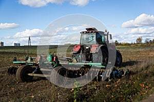 Agricultural machinery, prepares the land with a cultivator. Plowing a tractor