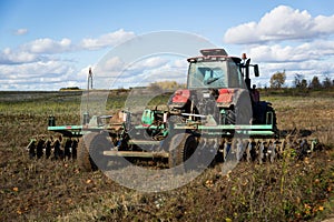 Agricultural machinery, prepares the land with a cultivator. Plowing a tractor