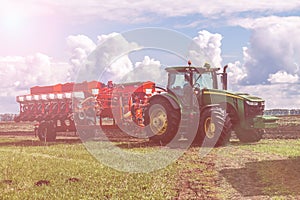Agricultural machinery, Tractor and farmer in agricultural fields of wheat and rapeseed