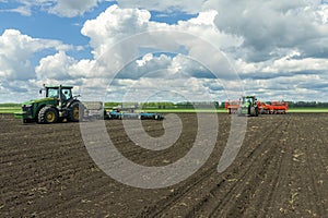 Agricultural machinery, Tractor and farmer in agricultural fields of wheat and rapeseed