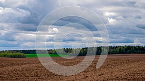 Agricultural ploughed field. Spring rural landscape