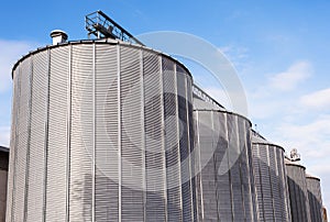 Agricultural silos on blue sky.