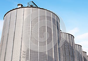 Agricultural silos on blue sky.