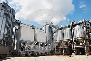 Agricultural Silos. Building Exterior. Storage and drying of grains, wheat, corn, soy, sunflower against the blue sky